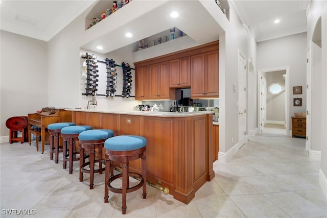 4323 Silver Fox Dr, Naples, FL 34119 - kitchen with crown molding, light countertops, a kitchen breakfast bar, recessed lighting, and a peninsula
