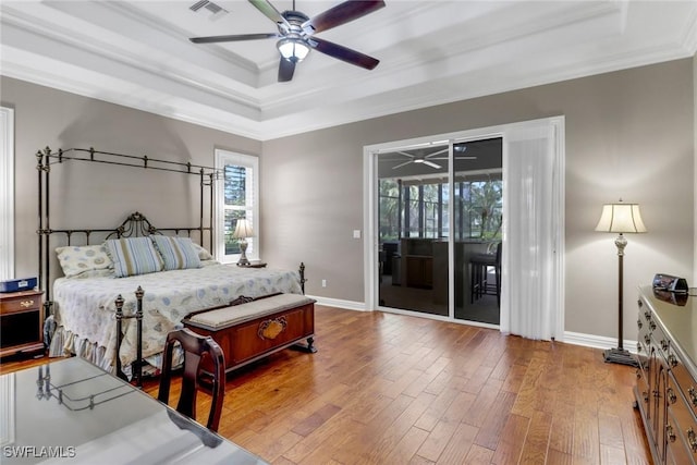 4323 Silver Fox Dr, Naples, FL 34119 - bedroom featuring a raised ceiling, access to exterior, crown molding, hardwood / wood-style floors, and a ceiling fan