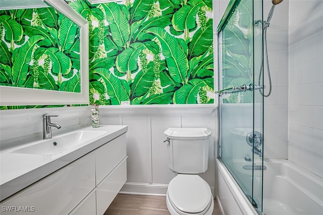 1674 Bunting Ln, Sanibel, FL 33957 - bathroom featuring vanity, bath / shower combo with glass door, and wood finished floors