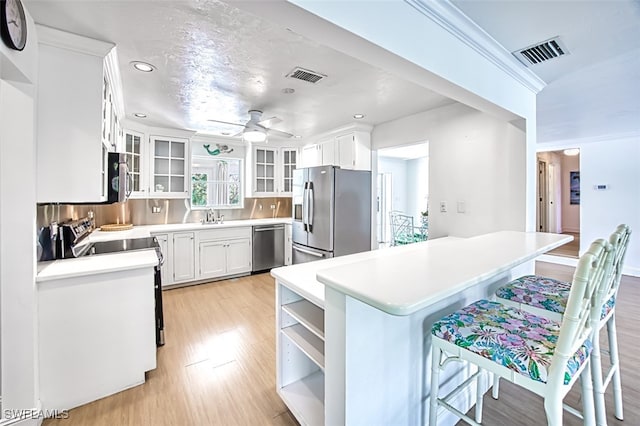 1674 Bunting Ln, Sanibel, FL 33957 - kitchen featuring stainless steel appliances, ceiling fan, recessed lighting, open shelves, and white cabinetry