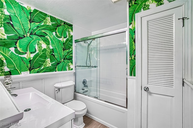 1674 Bunting Ln, Sanibel, FL 33957 - bathroom featuring shower / bath combination with glass door, wood finished floors, and vanity