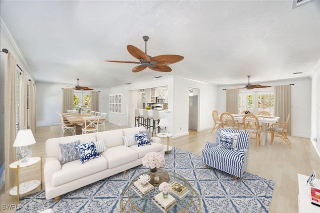 1674 Bunting Ln, Sanibel, FL 33957 - living room with ceiling fan, wood finished floors, and ornamental molding