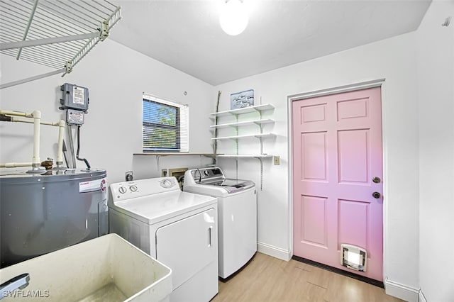 1674 Bunting Ln, Sanibel, FL 33957 - washroom with independent washer and dryer, light wood-type flooring, and electric water heater