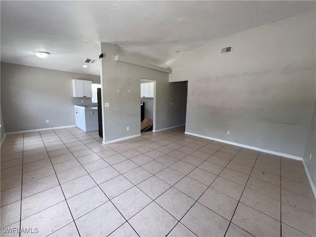 4869/4871 Leonard Blvd S, Lehigh Acres, FL 33973 - spare room with light tile patterned flooring and lofted ceiling