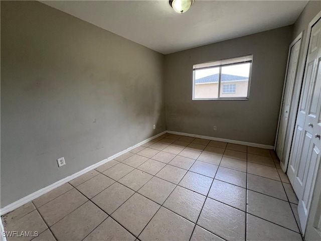 4869/4871 Leonard Blvd S, Lehigh Acres, FL 33973 - unfurnished bedroom featuring a closet and light tile patterned floors