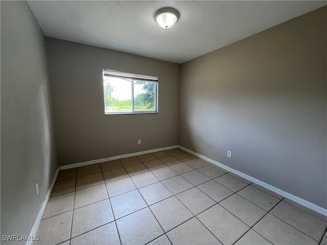 4869/4871 Leonard Blvd S, Lehigh Acres, FL 33973 - unfurnished room with light tile patterned flooring and baseboards