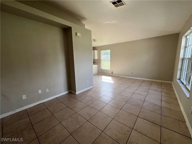 4869/4871 Leonard Blvd S, Lehigh Acres, FL 33973 - empty room featuring light tile patterned floors and baseboards
