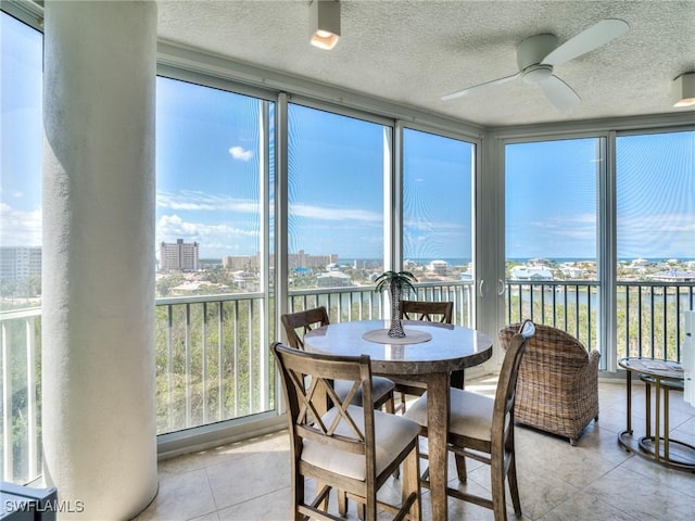 4182 Bay Beach Ln Unit 761, Fort Myers Beach, FL 33931 - sunroom featuring tile patterned floors, a textured ceiling, and a water view