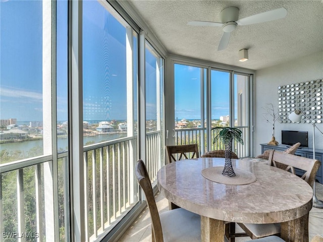 4182 Bay Beach Ln Unit 761, Fort Myers Beach, FL 33931 - sunroom / solarium with floor to ceiling windows, a water view, and a textured ceiling