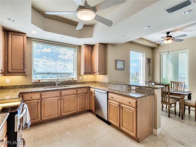 4182 Bay Beach Ln Unit 761, Fort Myers Beach, FL 33931 - kitchen featuring dishwasher, ceiling fan, a tray ceiling, a peninsula, and range with electric stovetop