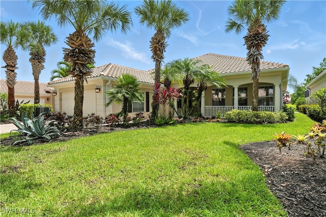 28283 Koi Way, Bonita Springs, FL 34135 - mediterranean / spanish home with a garage, a front yard, a tile roof, a porch, and stucco siding