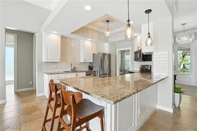28283 Koi Way, Bonita Springs, FL 34135 - kitchen with appliances with stainless steel finishes, a peninsula, white cabinets, backsplash, and recessed lighting