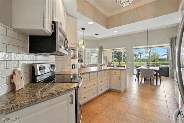 28283 Koi Way, Bonita Springs, FL 34135 - kitchen featuring stainless steel appliances, crown molding, recessed lighting, decorative backsplash, and white cabinets