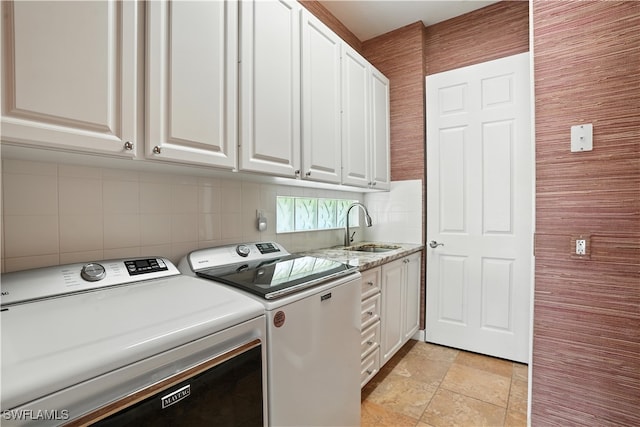 28283 Koi Way, Bonita Springs, FL 34135 - washroom featuring washing machine and clothes dryer, cabinet space, and light stone finish flooring