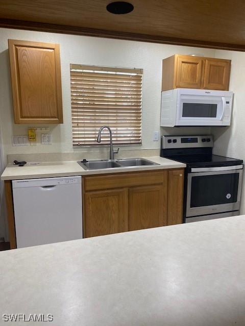 5265 Leeds Rd, Fort Myers, FL 33907 - kitchen featuring white appliances, light countertops, and ornamental molding