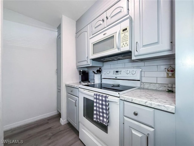 13126 Feather Sound Dr Unit 310, Fort Myers, FL 34481 - kitchen featuring white appliances, decorative backsplash, light countertops, and wood finished floors