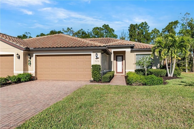 9078 Triangle Palm Ln, Fort Myers, FL 33913 - mediterranean / spanish home featuring an attached garage, stucco siding, decorative driveway, a front lawn, and a tile roof