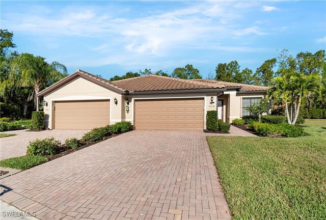 9078 Triangle Palm Ln, Fort Myers, FL 33913 - view of front of house with decorative driveway, stucco siding, an attached garage, and a front lawn