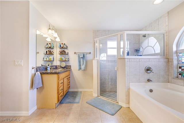 606 Mohawk Pkwy, Cape Coral, FL 33914 - full bath with vanity, a bath, a shower stall, and tile patterned floors