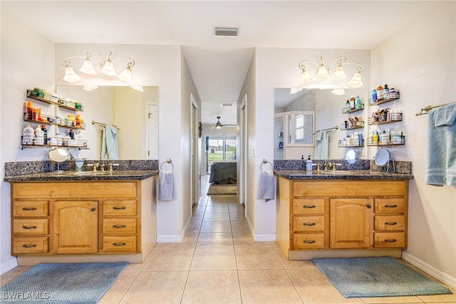 606 Mohawk Pkwy, Cape Coral, FL 33914 - bathroom featuring connected bathroom, two vanities, tile patterned flooring, and a ceiling fan