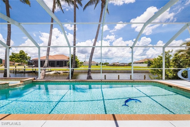 606 Mohawk Pkwy, Cape Coral, FL 33914 - view of swimming pool featuring a pool with connected hot tub, glass enclosure, and a water view