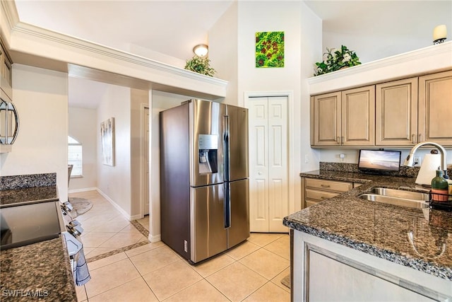 606 Mohawk Pkwy, Cape Coral, FL 33914 - kitchen with stainless steel appliances, light tile patterned flooring, dark stone counters, and high vaulted ceiling