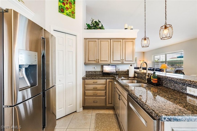 606 Mohawk Pkwy, Cape Coral, FL 33914 - kitchen featuring stainless steel appliances, a peninsula, light tile patterned floors, light brown cabinets, and hanging light fixtures