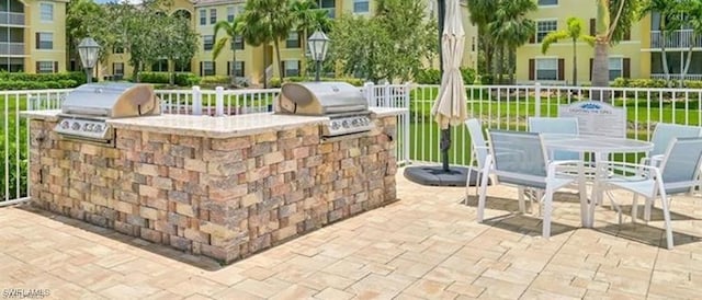 4105 Residence Dr Unit 722, Fort Myers, FL 33901 - view of patio with exterior kitchen and outdoor dining space