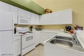4105 Residence Dr Unit 722, Fort Myers, FL 33901 - kitchen with white appliances, white cabinetry, and light tile patterned flooring