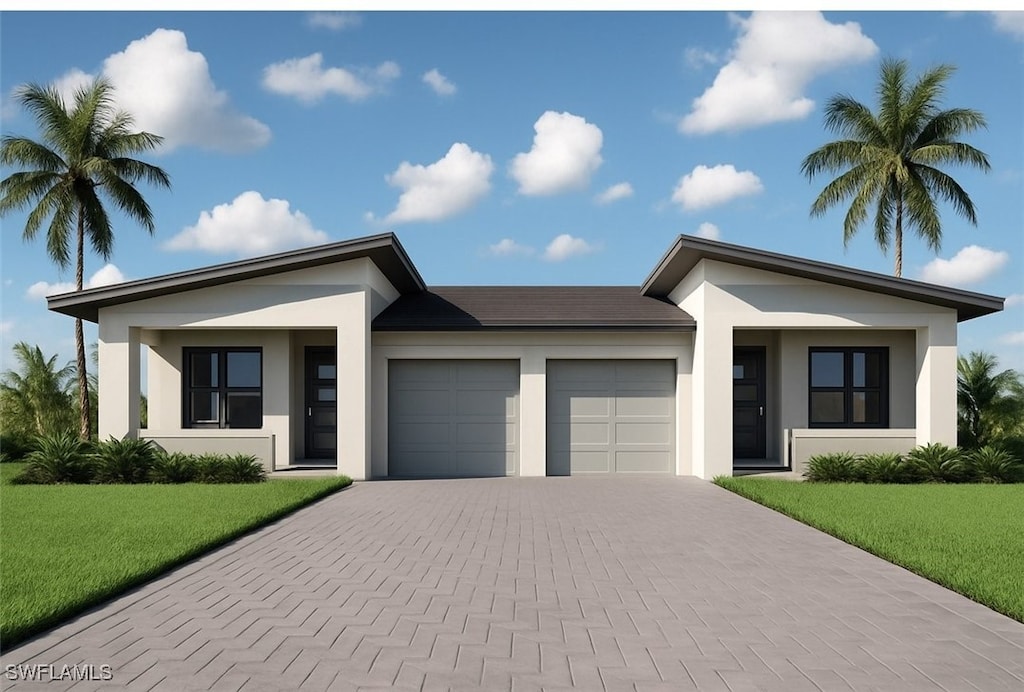 5043/5045 Benton St, Lehigh Acres, FL 33971 - view of front of house with stucco siding, a garage, decorative driveway, and a front yard