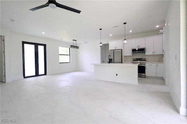 2713 8th St W, Lehigh Acres, FL 33971 - kitchen with appliances with stainless steel finishes, open floor plan, recessed lighting, white cabinetry, and a center island