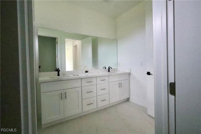 2713 8th St W, Lehigh Acres, FL 33971 - bathroom with double vanity and baseboards