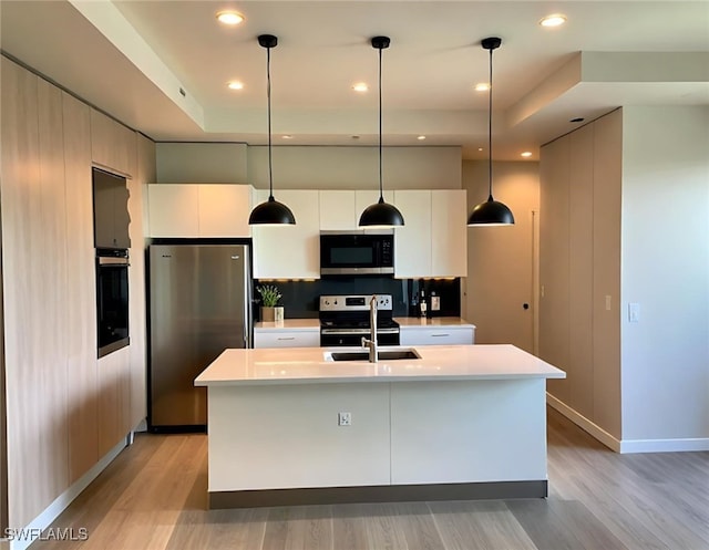 3113 58th St W, Lehigh Acres, FL 33971 - kitchen with appliances with stainless steel finishes, modern cabinets, light wood-style floors, light countertops, and recessed lighting