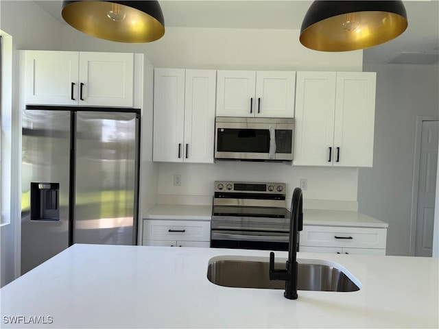 3113 58th St W, Lehigh Acres, FL 33971 - kitchen featuring appliances with stainless steel finishes, light countertops, and white cabinetry