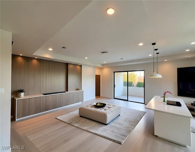3113 58th St W, Lehigh Acres, FL 33971 - living room featuring light wood-type flooring, recessed lighting, and a tray ceiling