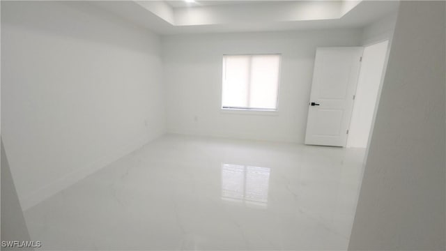 1215 Bayou St, Lehigh Acres, FL 33974 - unfurnished room featuring a tray ceiling