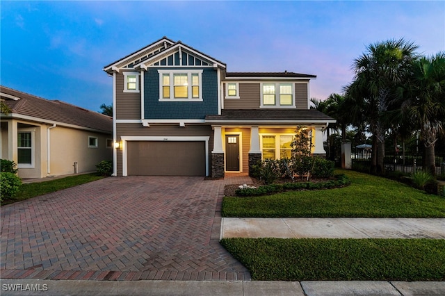 3240 Pilot Cir, Naples, FL 34120 - view of front facade featuring a garage, decorative driveway, stone siding, and a front yard