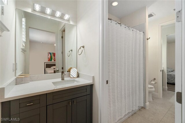 3240 Pilot Cir, Naples, FL 34120 - ensuite bathroom featuring vanity and tile patterned floors