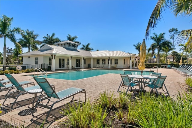 3240 Pilot Cir, Naples, FL 34120 - community pool featuring a patio and french doors