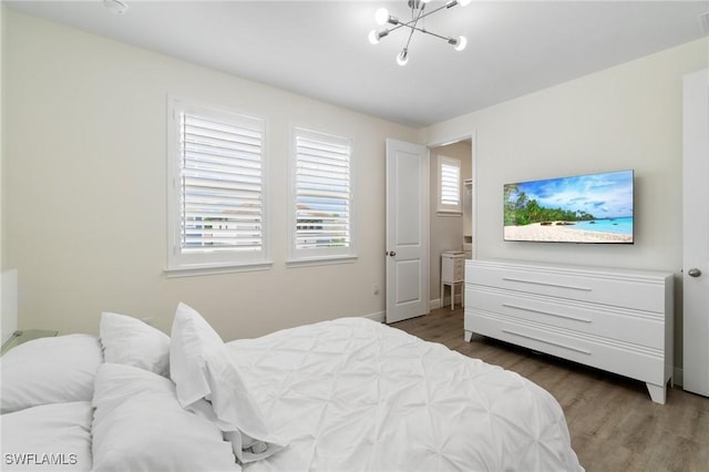 3240 Pilot Cir, Naples, FL 34120 - bedroom featuring a chandelier and wood finished floors