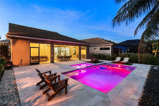 3240 Pilot Cir, Naples, FL 34120 - view of swimming pool featuring a pool with connected hot tub, a patio area, and outdoor dining space