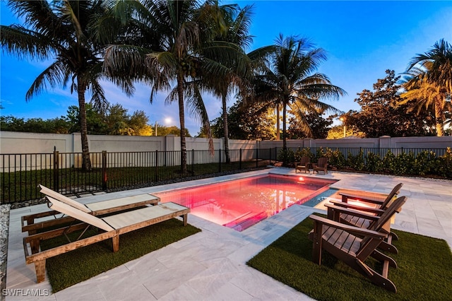 3240 Pilot Cir, Naples, FL 34120 - pool at dusk with a patio area