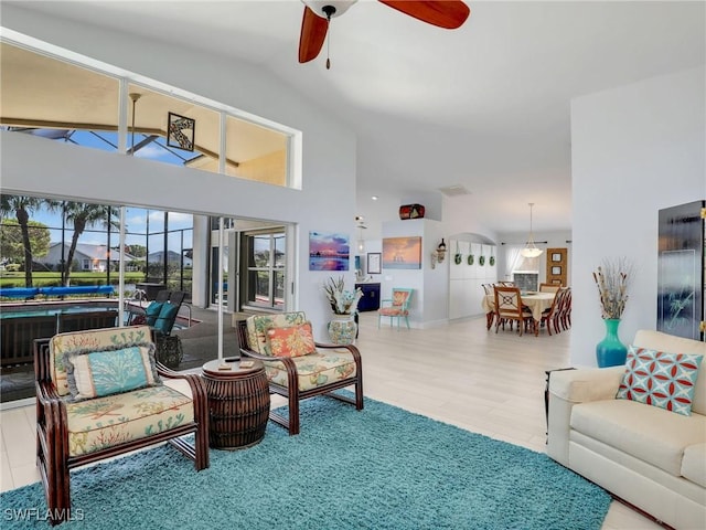 14891 Lake Olive Dr, Fort Myers, FL 33919 - living room with a ceiling fan, wood finished floors, and high vaulted ceiling
