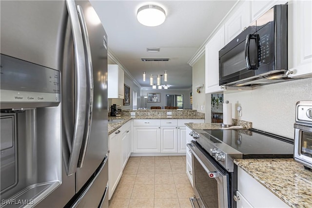 1271 16th St NE, Naples, FL 34120 - kitchen with stainless steel appliances, white cabinets, light tile patterned floors, decorative light fixtures, and light stone countertops