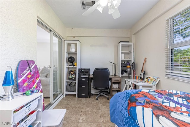 1271 16th St NE, Naples, FL 34120 - tiled bedroom with an office area and a ceiling fan