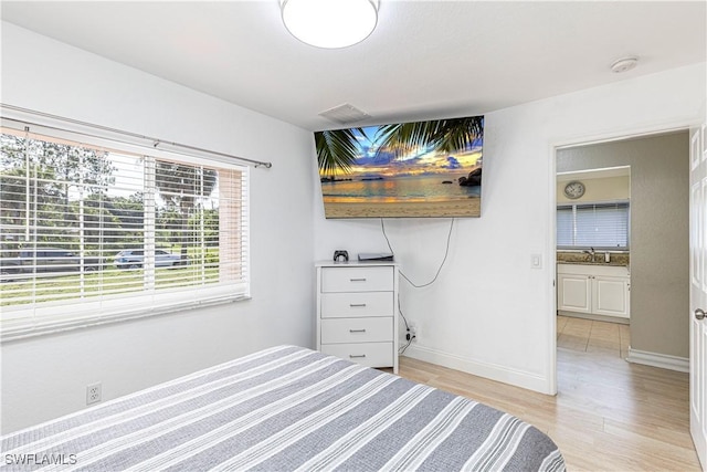 1271 16th St NE, Naples, FL 34120 - bedroom featuring light wood finished floors and baseboards