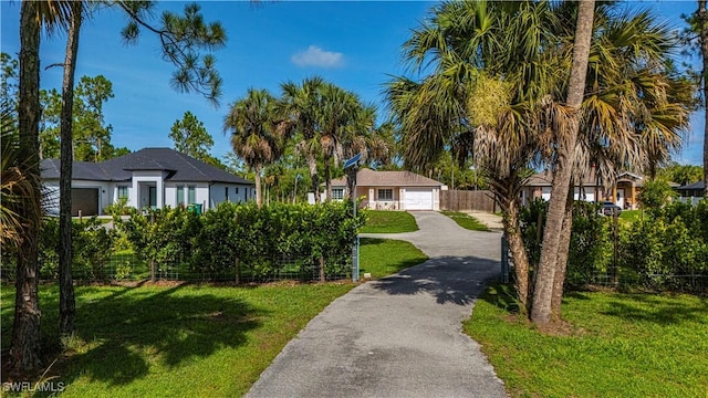 1271 16th St NE, Naples, FL 34120 - view of front facade featuring driveway and a garage