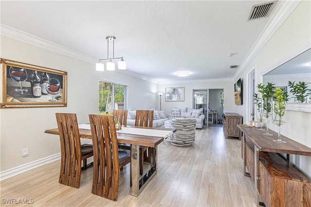 1271 16th St NE, Naples, FL 34120 - dining room with light wood-style floors and crown molding