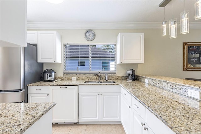 1271 16th St NE, Naples, FL 34120 - kitchen with freestanding refrigerator, white cabinetry, crown molding, light stone counters, and pendant lighting