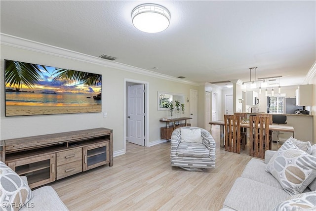 1271 16th St NE, Naples, FL 34120 - living room featuring ornamental molding and light wood finished floors